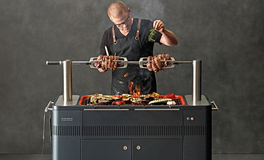 an image of Everdure Hub Deluxe Outdoor Kitchen Combo being used by a chef to cook meat and vegetables