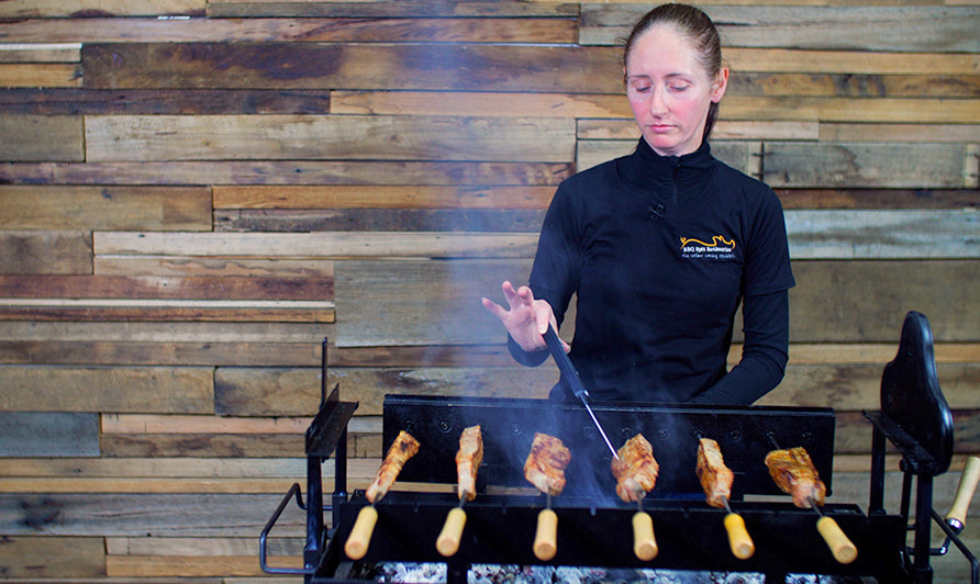 This image shows pork belly placed in the skewer and checking internal temperature of meat