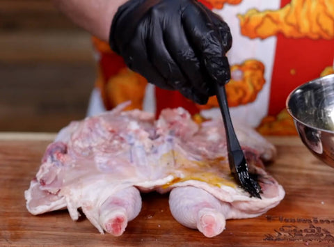 This image shows applying the Peri Peri seasoning with olive oil to the chicken