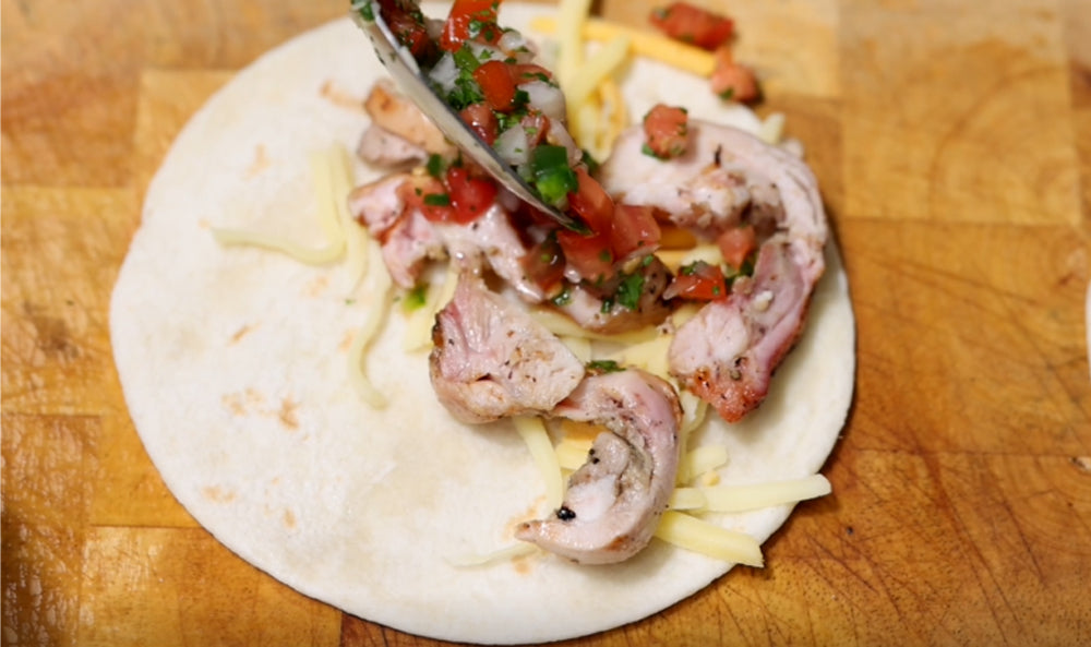 This_image_Chicken_tacos_being_assembled