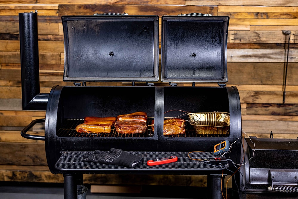 This_image_shows_various_meat_cooked_Offset_Flaming_coals_Offset_Smoker