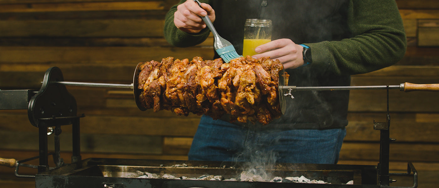 This image shows a man basting the meat with lemon juice