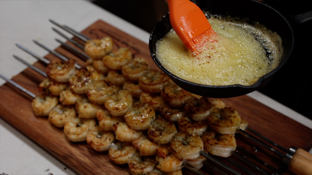 This image shows prawns basted with melted butter