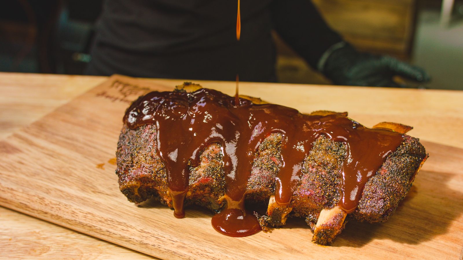 This image shows beef ribs with Kosmso Q Bbq Sauce