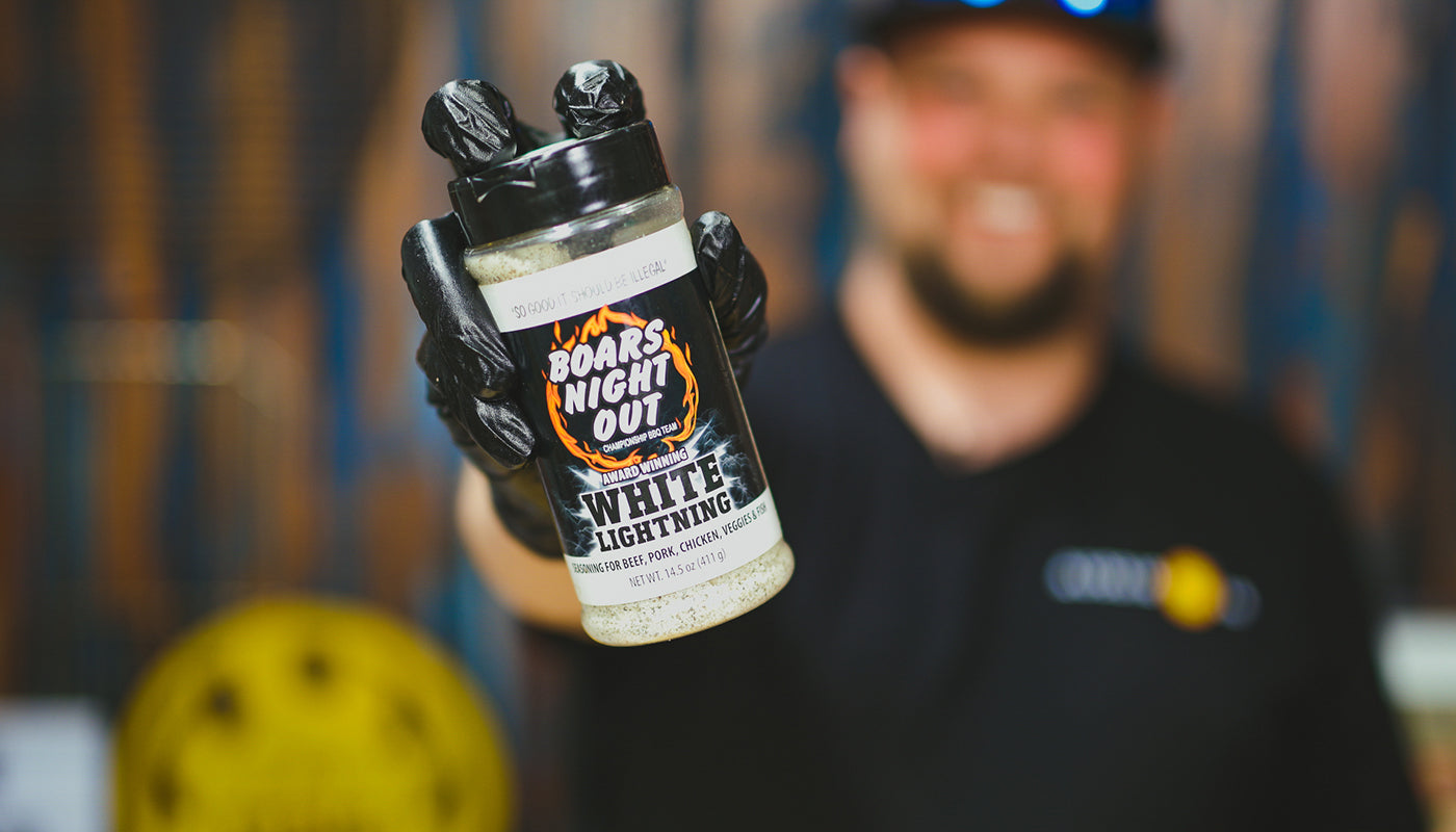 This image shows Westy from Slow Burner Bbq holding the Boars night out white lightning rub. 