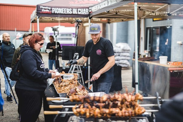 This_image_shows_Boomas_serving_the_customer_a_cooked_whole_hog