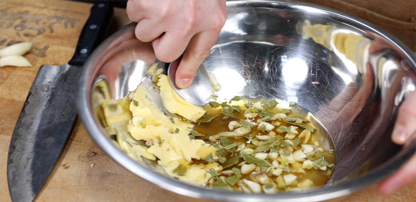 This image shows butter, garlic and ginger in a bowl