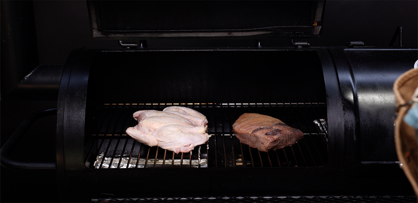 This image shows the butterflied chicken in the offset smoker