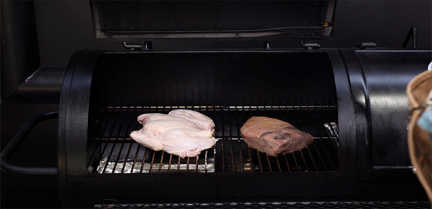 This image shows the butterflied chicken in the offset smoker