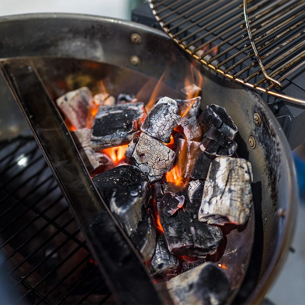 This photo shows the charcoal lit on a Kettle BBQ.