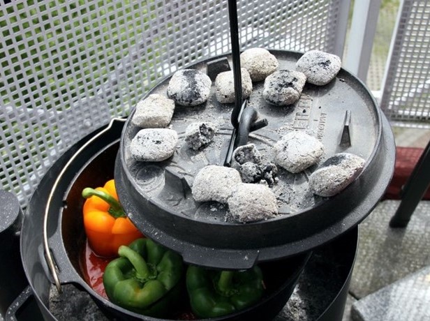 This is a picture to the dutch oven, camp oven lid lifter being used to lift a lid