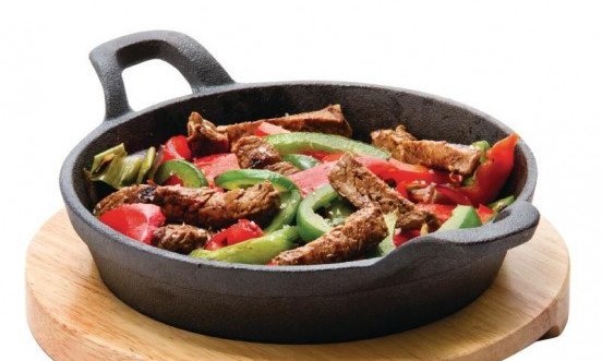 this picture shows the cast iron round eared dish with cooked veggies
