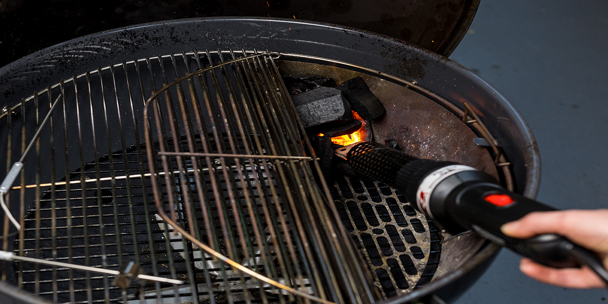 This image shows a little amount of charcoal lit by charcoal starter wand on SNS kettle