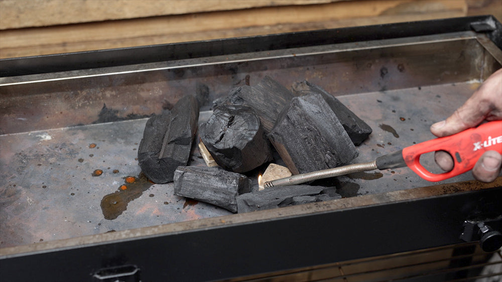 This image shows charcoals being lit for cooking chicken wings