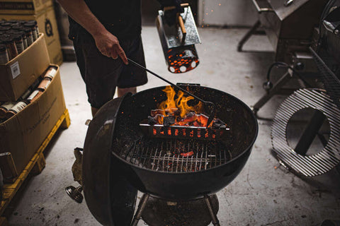 This_image_shows_charcoal_rake_being_used_to_spread_charcoal