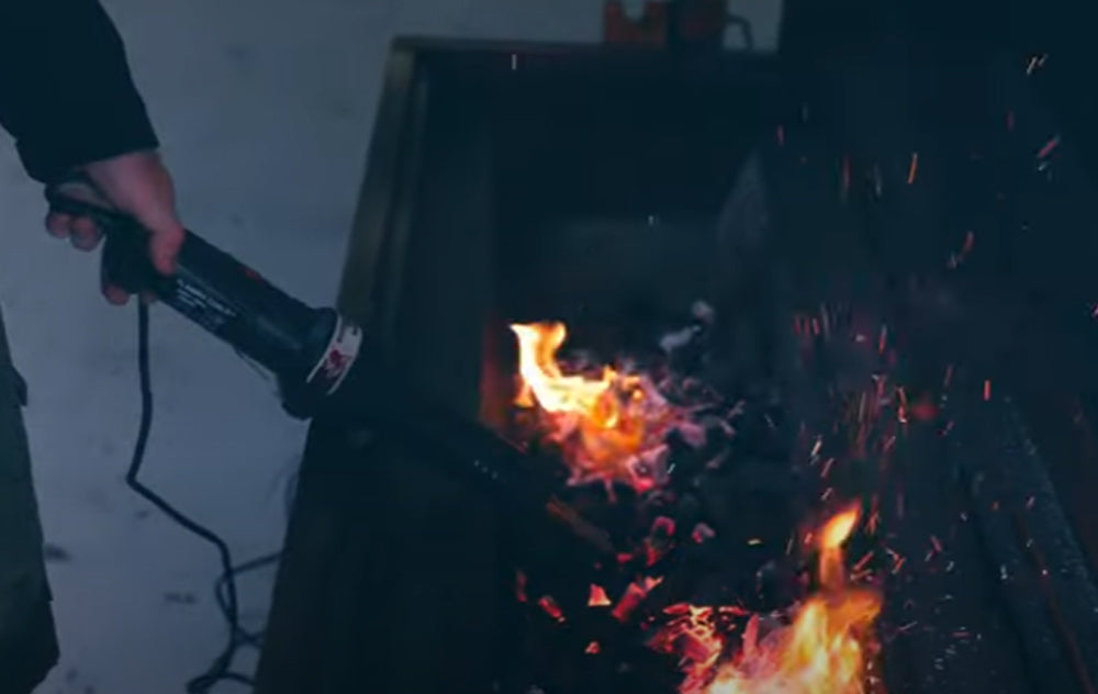 This_image_shows_charcoal_starter_wand_being_used_to_lit_the_charcoal