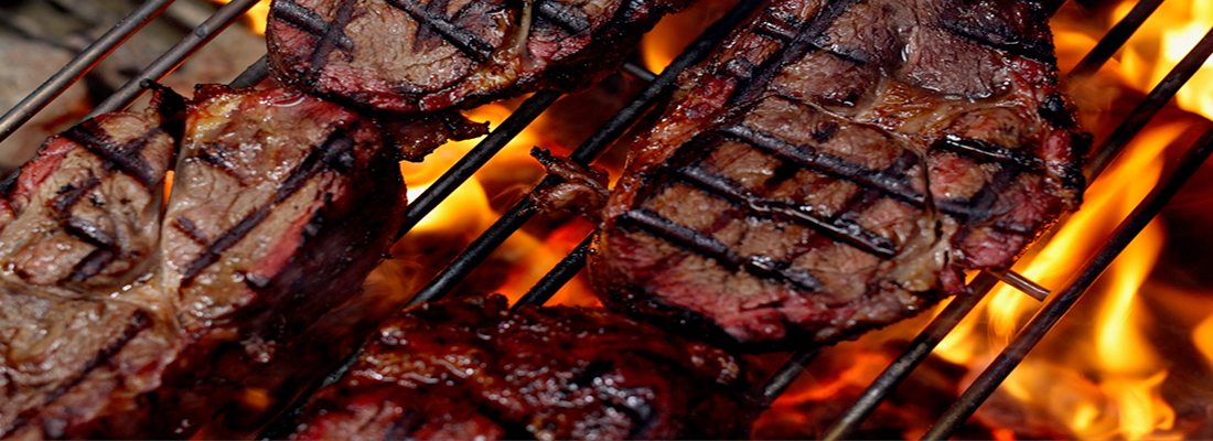 This photo shows steak cooking on a Grill