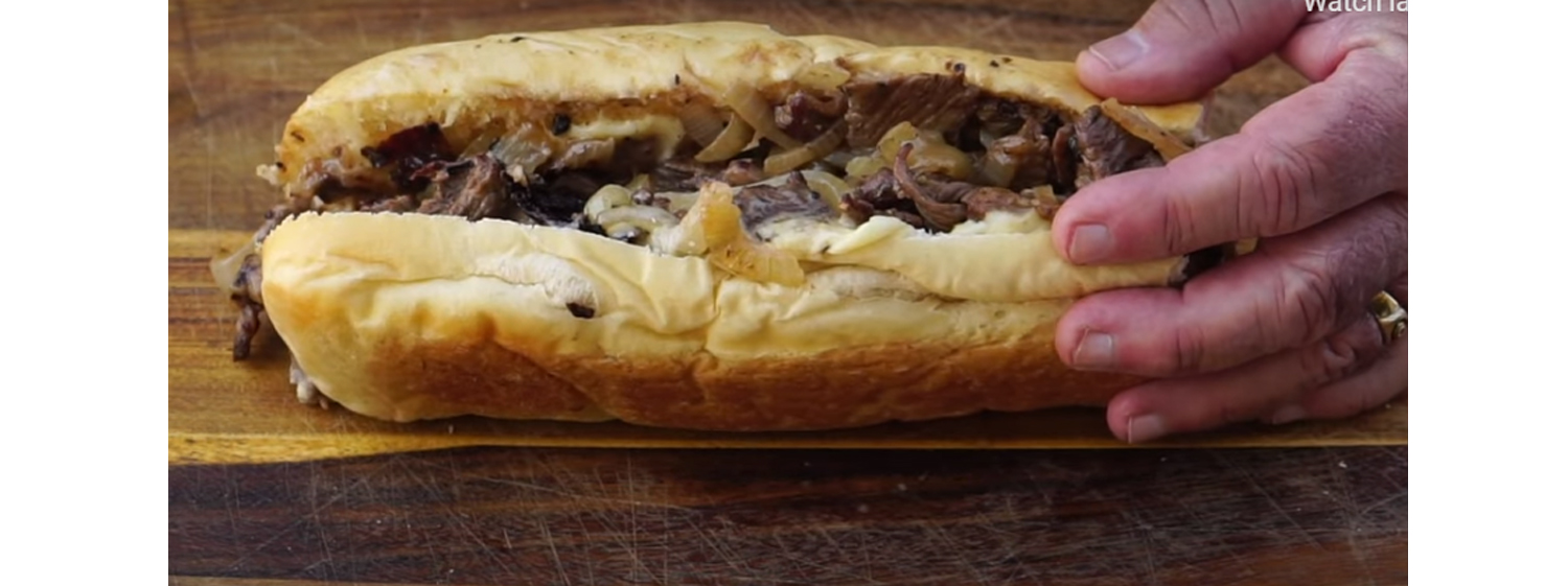 This image shows a cheesesteak sandwich