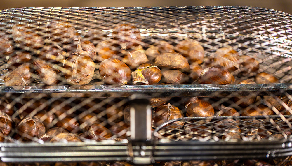 This image shows chestnuts on a rotisserie tumbler This image shows chestnuts on a rotisserie tumbler