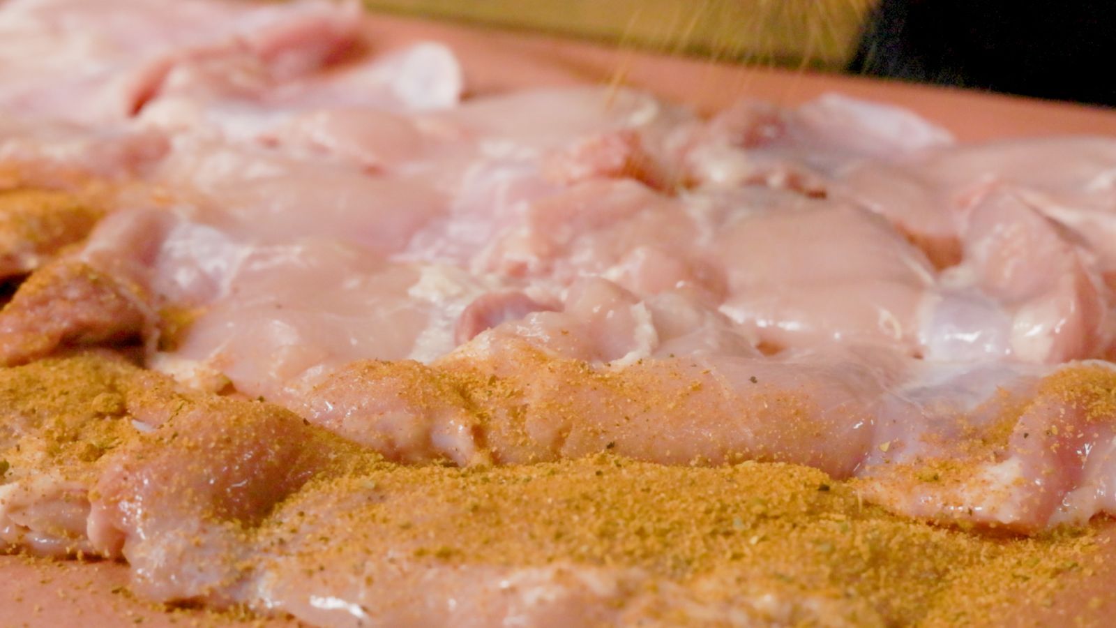 This_image_shows_chicken_gyros_being_seasoned_with_Flaming_Coals_Gyros_Rub