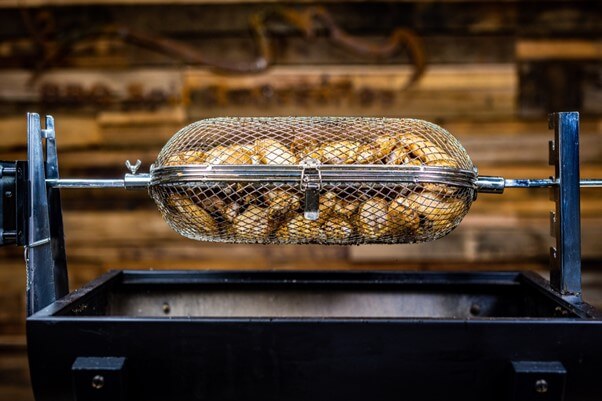 This image shows chicken nibbles in rotisseries basket cooked on Mini Spit roaster