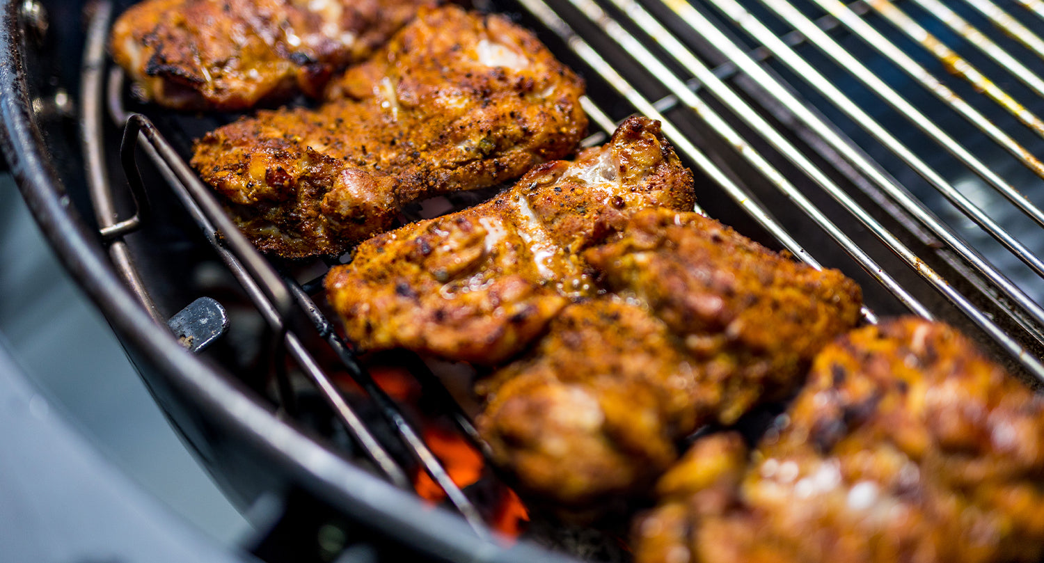 This image shows chicken thighs placed on direct heat