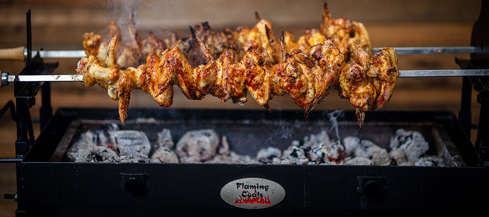 This image shows chicken wings cooked in a Cyprus Spit Roaster