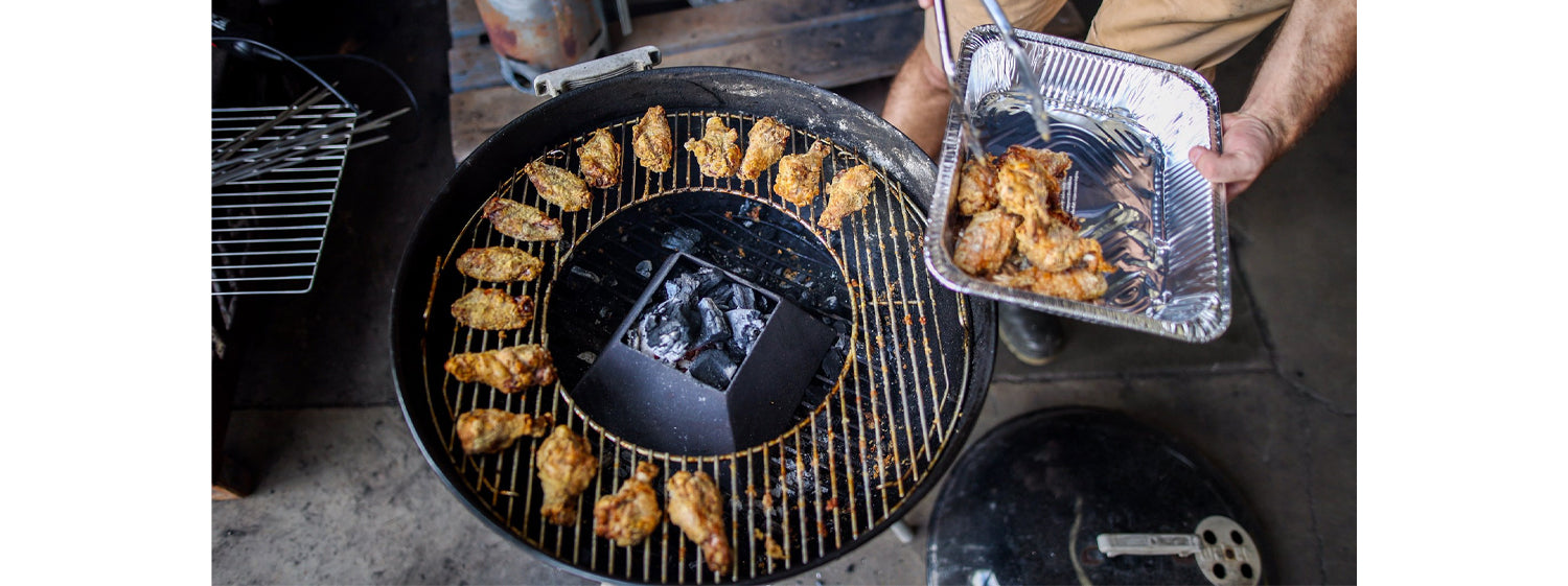 This image shows chicken wings on the weber kettle