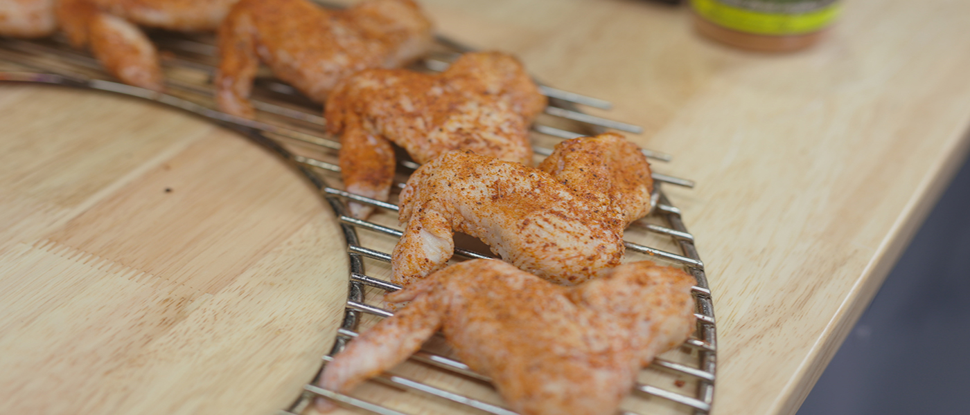 This image shows chicken wings assembled on SNS Removable kettle grill