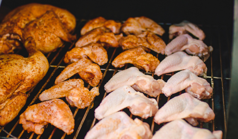 This_image_shows-Chicken_wings_being_cooked_on_offset_smoker