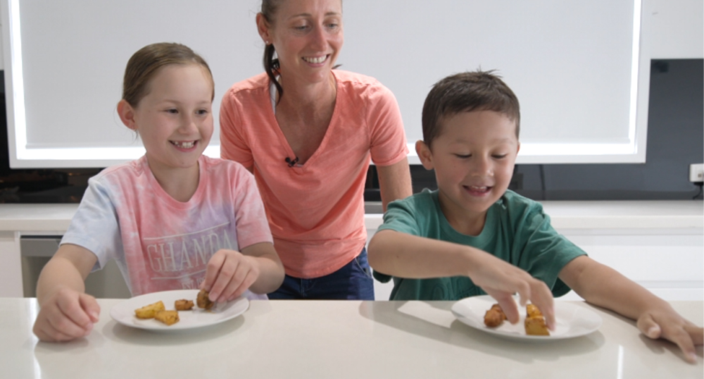 This_image_shows_the_kids_enjoying_the_Chicken_and_potatoes
