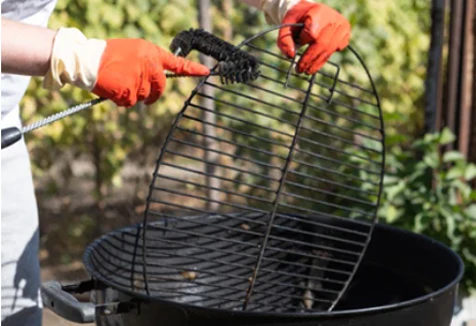 This_image_shows_cleaning_bbq_grill_