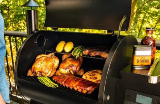 This photo shows Traeger Pro 575 Grill with meats and veggies being cooked.