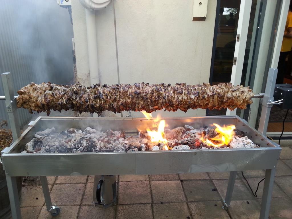 This image shows souvlaki cooked on spit roaster