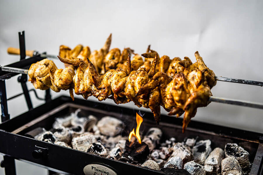 This_image_shows_chicken_wings_cooked_on_Cyprus_Spit_Souvla