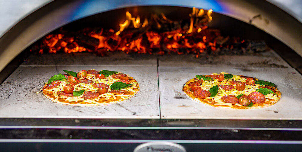 This image shows Pizzas on wood fired pizza oven