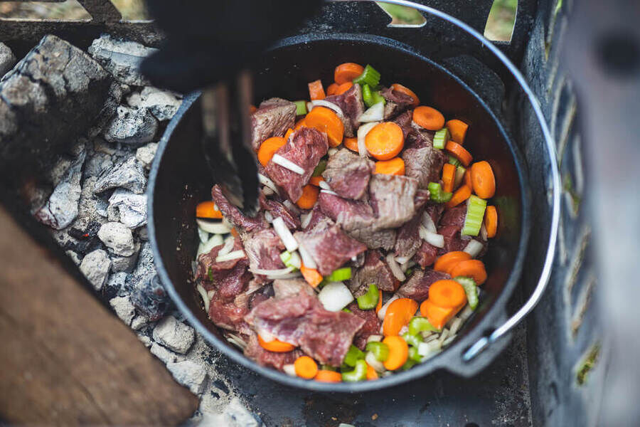 Flaming Coals Cast Iron Camp Oven 9QT 12" with meat and vegetables 