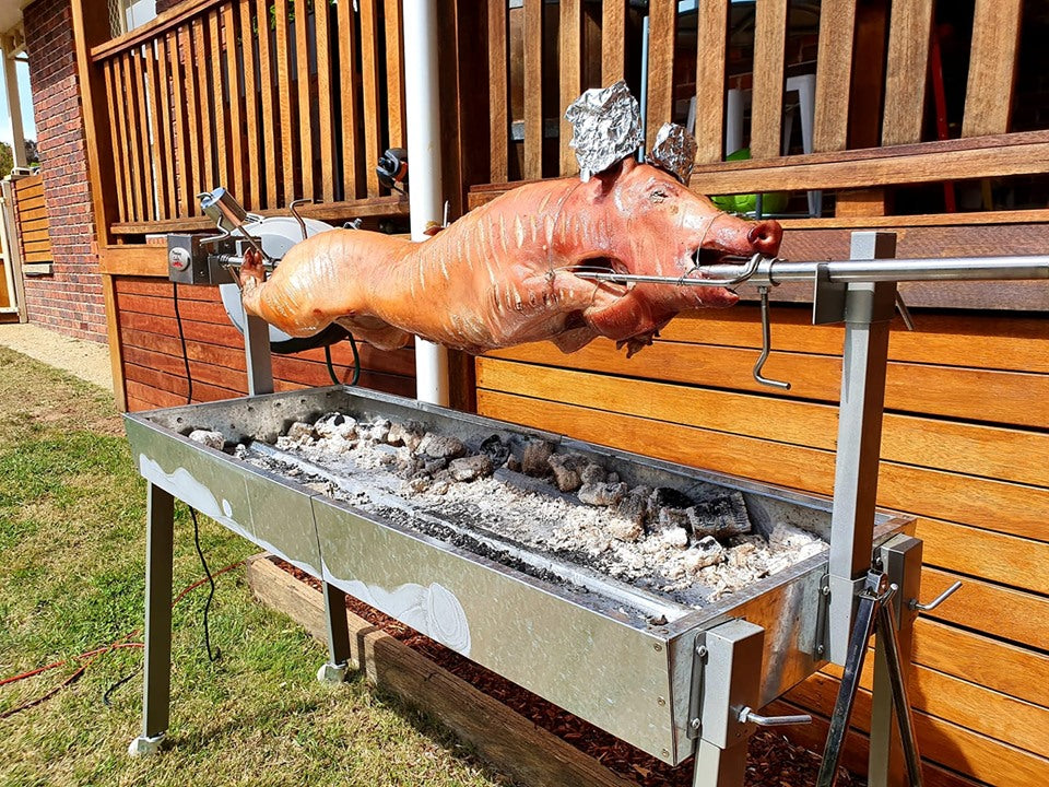 This is an image supplied by a customer who cooked a whole pig on an extendable spit roaster