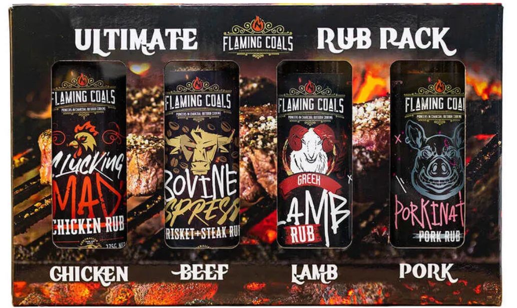 Flaming Coals Ultimate Rub Rack featuring four BBQ rubs: Clucking Mad Chicken Rub, Bovine Espresso Brisket & Steak Rub, Green Lamb Rub, and Porkinator Pork Rub.