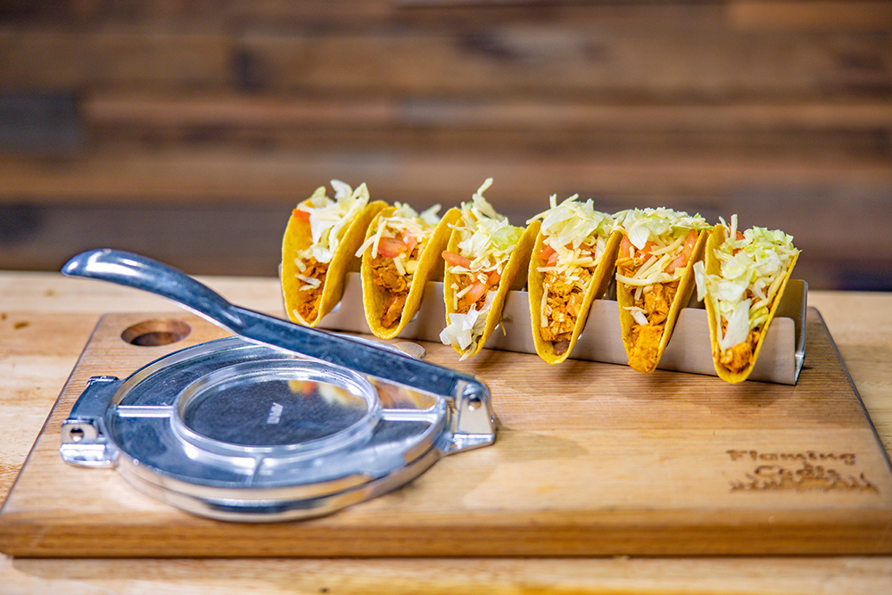 This image shows Taco holder and tortilla press with delicious tacos