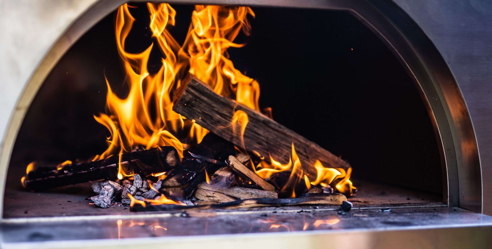 This image shows a fire started on Wood Fired pizza Oven