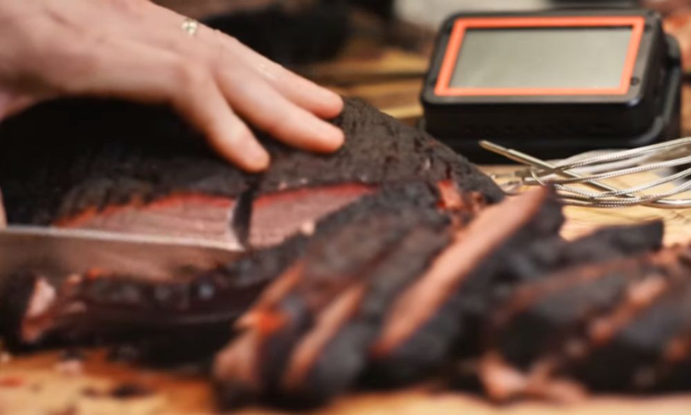 Fireboard Pro thermometer with high heat probes monitoring sliced brisket during barbecue cook