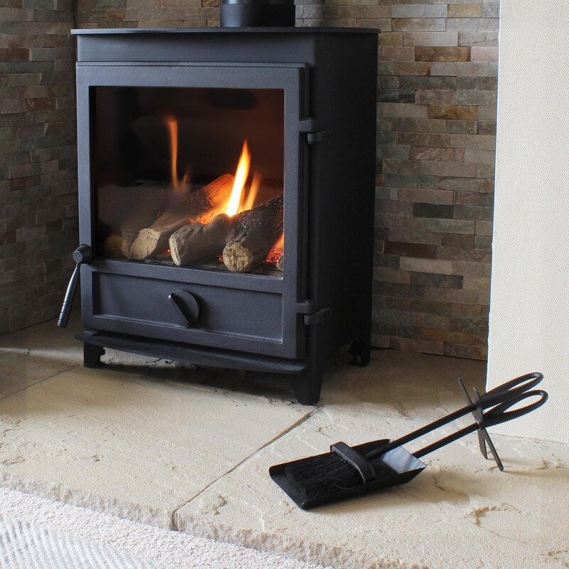 This image show a picture of the Fireplace Brush & Shovel set in from of an open fireplace