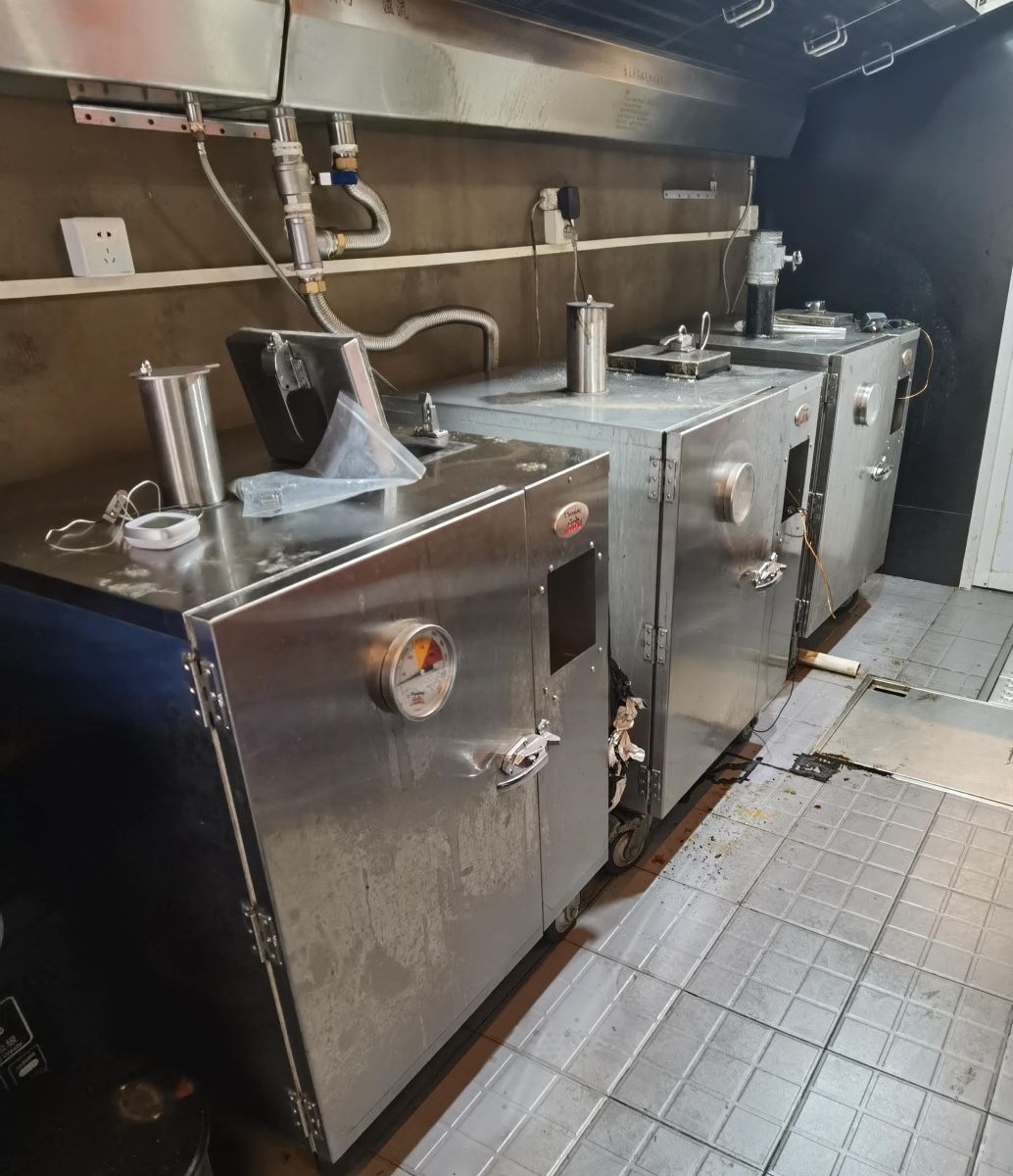 This is a picture of 3 gravity feed smokers setup in a commercial environment in a restaurant and used daily for cooking smoked food