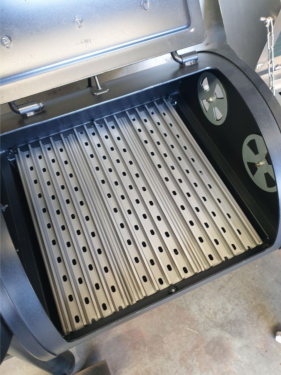 Image shows grillgrates in the firebox of a hark offset smoker firebox.