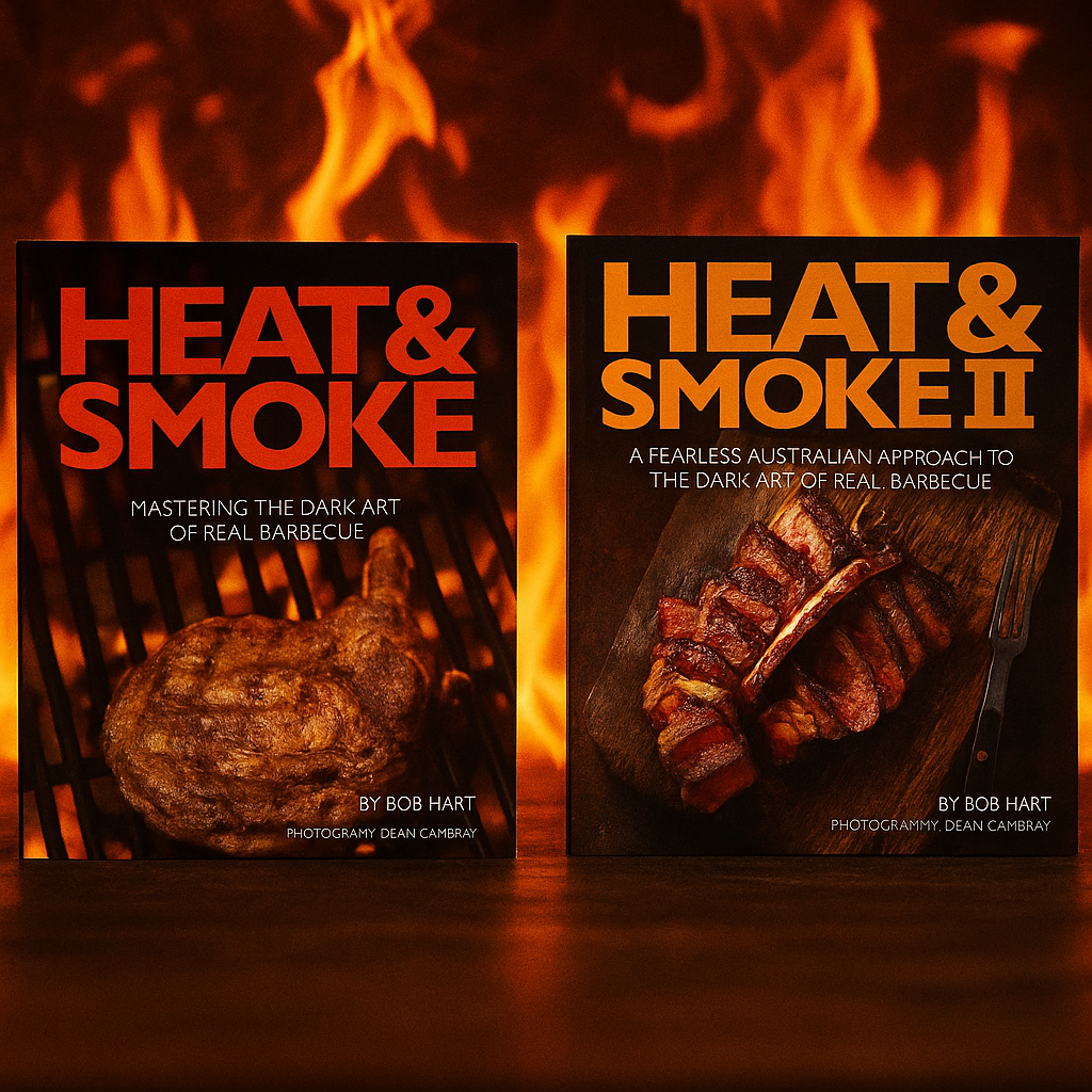 Two 'Heat & Smoke' BBQ cookbooks by Bob Hart displayed side by side with a fiery background, emphasizing their barbecue theme and bold cover designs.