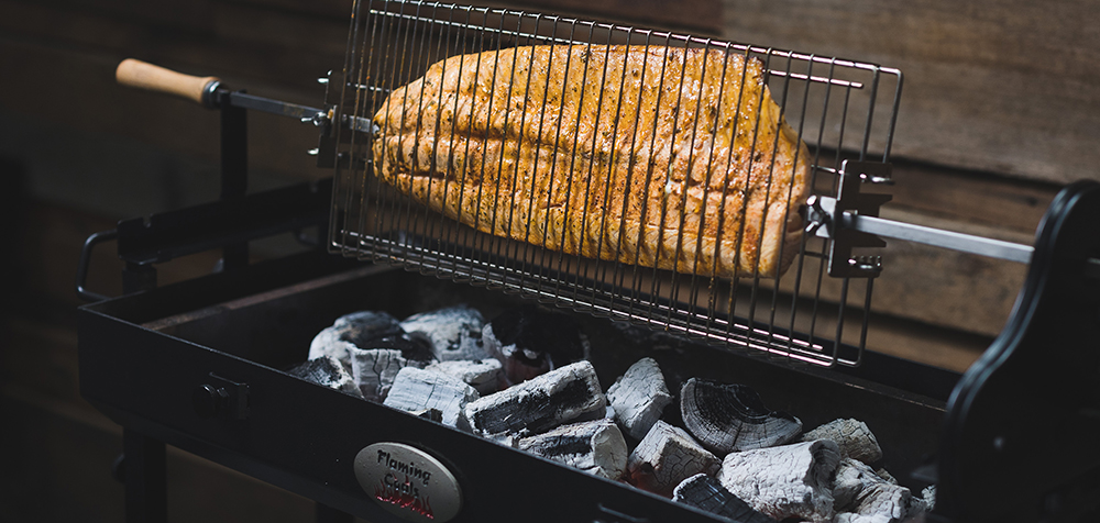 This image shows a salmon being cooked in the Cyprus Spit Roaster. 