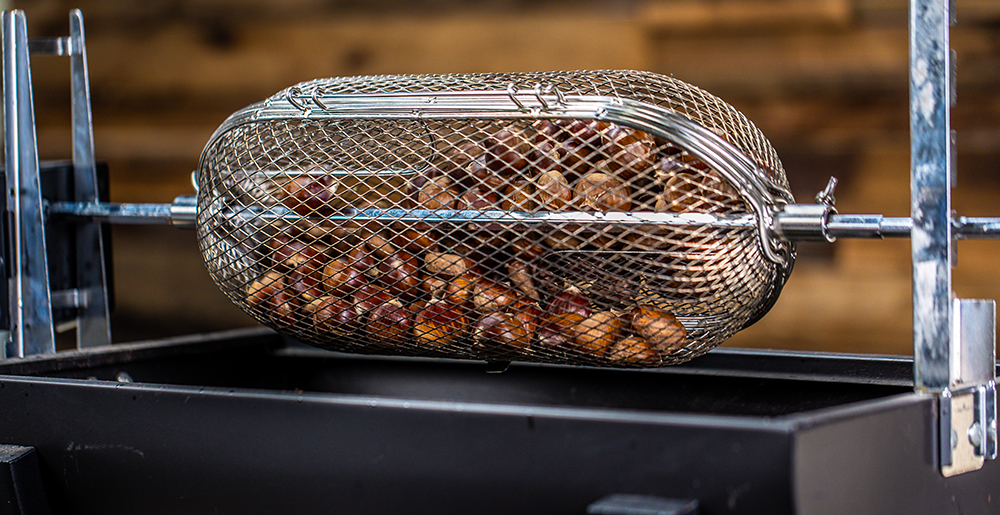 This image shows chestnuts being roast in the spit roaster