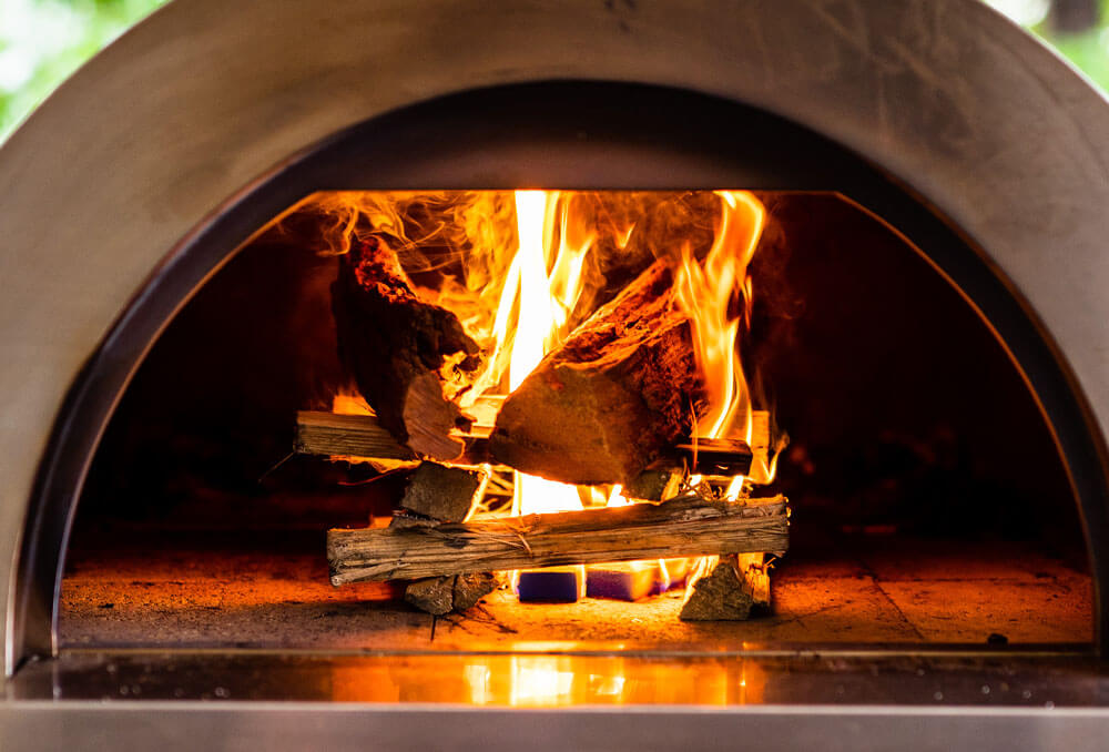 This image shows wood kindling inside the pizza oven