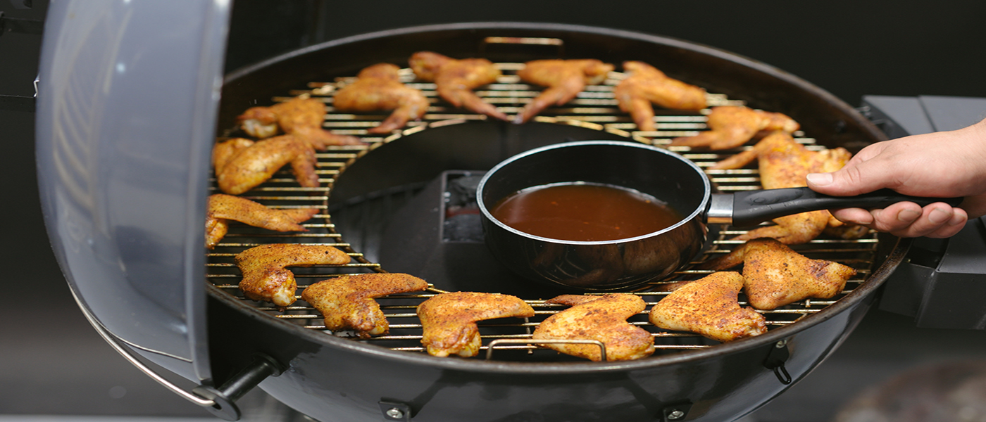 This image shows the kosmos rib glaze heated on Kettle kone and chicken wings. 
